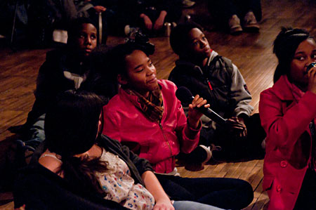 A guest poses a question to the cast during the artistic discussion