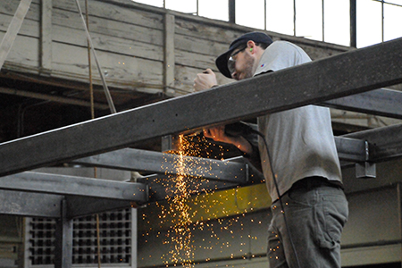 Nate Crawford welding a steel bridge