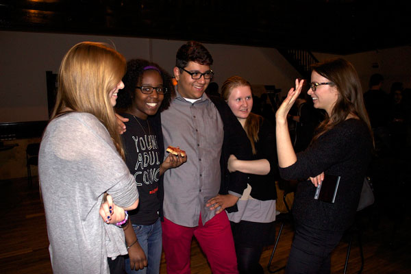 Carolyn Braver (Jeannie from <em>Leveling Up</em>) chats with a group of teens.