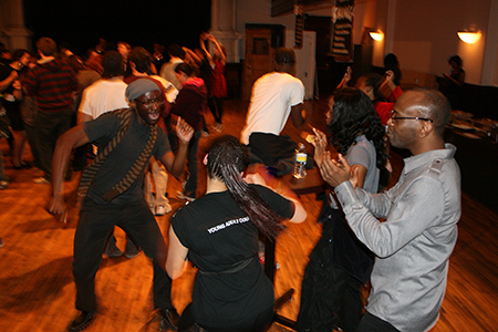 Phillip James Brannon (Oshoosi), K. Todd Freeman (Ogun) and Tamberla Perry (Shun/Osha) dance with Young Adult Council member Brittany Stokes.