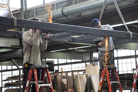 Ken Blenc and Nate Crawford welding a steel bridge