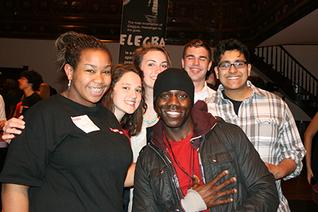 Actor Rodrick Covington (Shango) poses for a picture with teens who attended the play.