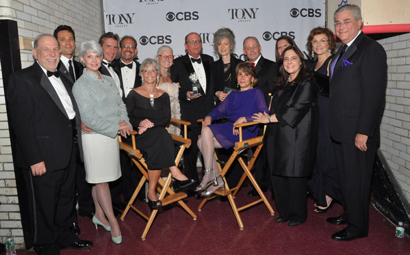 Executive Director David Hawkanson and Artistic Director Martha Lavey (center) with the Broadway producers and the award for Best Revival of a Play